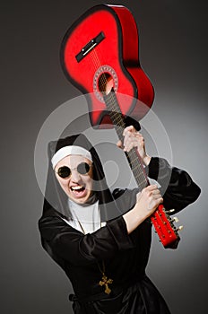 The funny nun with red guitar playing