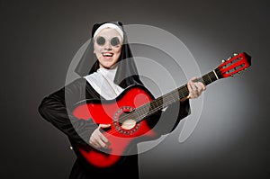 The funny nun with red guitar playing