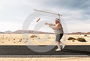 Funny overweight man chasing the hot dog photo