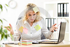 Funny overworked business woman working in office