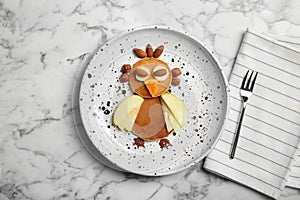 Funny pancakes for kids breakfast on marble table