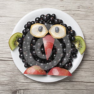 Funny penguin made with currant and apple