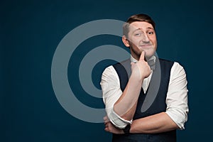 Funny pensive young man in formal clothes