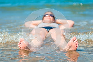 Funny photo of a beautiful girl lying in sea