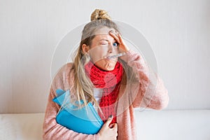 Funny picture of sick woman measuring temperature with thermometer in her mouth