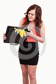 funny picture of young business woman trying to close her briefcase after she put in it yellow rubber gloves