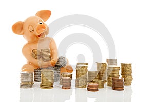 Funny piggy bank and piles of coins
