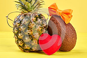 Funny pineapple in glasses and coconut.