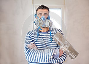 Funny plastering man mason with protective mask and trowel