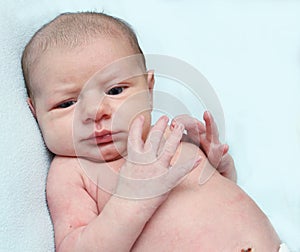 Funny plotting thinking blue eyed newborn baby
