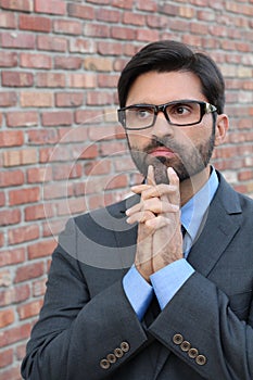 A funny pondering businessman with glasses