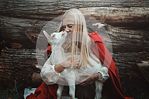 Funny portrait of blond woman and her goat