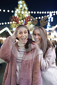 Funny portrait of friends wearing deer hairband