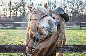 Funny portrait of a girl with an horse