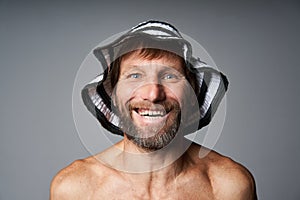 Funny portrait of mature man topless wearing summer hat