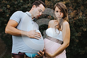 Funny portrait of pregnant wife and pregnant husband