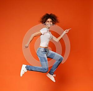 Funny portrait on young african american woman in humorous jump