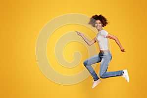 Funny portrait on young african american woman in humorous jump