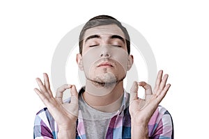 Funny portrait of a young man with a blissful face, showing hands OK sign, happy gourmet