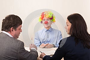 Funny portrait of young man during job interview and members of