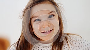 Funny preschool girl making silly faces, candid lifestyle child portrait with emotions