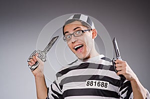 Funny prisoner with knuckles isolated on gray