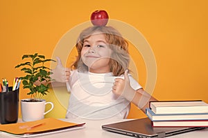 Funny pupil. Nerd school kid isolated on studio background. Clever child from elementary school with book. Smart genius