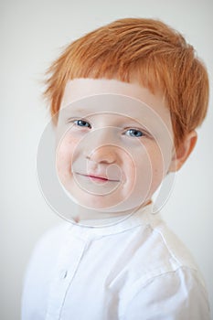 Funny red-haired boy in a shirt