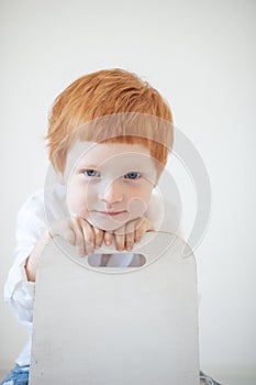 Funny red-haired boy in a shirt