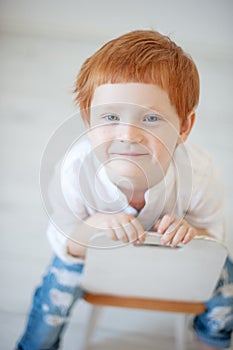 Funny red-haired boy in a shirt