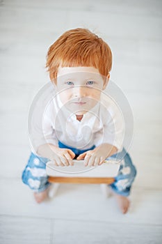 Funny red-haired boy in a shirt