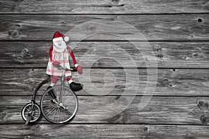 Funny red santa claus on wooden grey background in hurry for buy