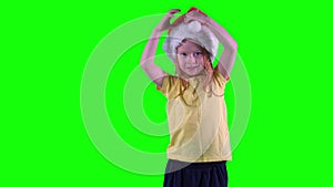 Funny redhead girl plays with Christmas hat. Chroma key green background