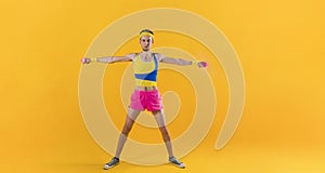 Funny retro sport nerd lifting weights on yellow background.