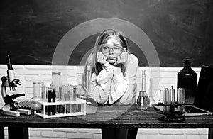Funny sad schoolgirl scientist in the laboratory. Chemical experiment. Funny schoolgirl kid doing experiments in the