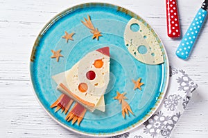 Funny sandwich with rocket and stars made of cheese, carrot and paprika, meal for kids idea