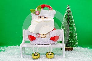 Funny Santa Claus on a bench.New Year and Christmas concept