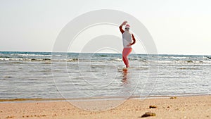 Funny Santa Claus. Father Christmas, in sunglasses and flippers, having fun in the sea water near sandy beach. Santa