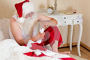 Funny Santa Claus mending socks photo