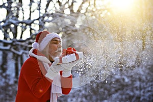 Funny Santa with Gift on Christmas Eve outside.