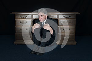 Funny Scared Fear Businessman Hide Under Office Desk photo