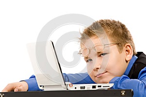 Funny school boy with laptop isolated on white