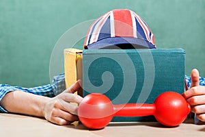 Funny schoolboy wearing baseball cap learning