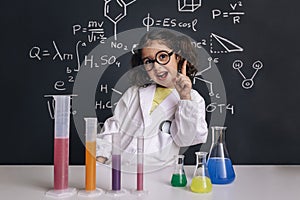 Funny scientist child in lab coat having an idea