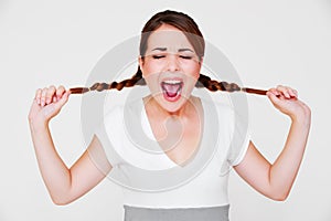 Funny screaming girl with two pigtails