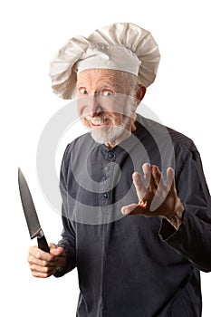 Funny senior chef with knife