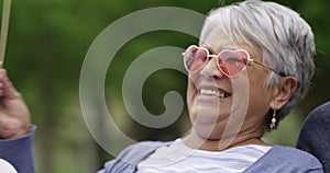 Funny, senior friends and face outdoor in the park for costume, party or portrait in photoshoot. Old people, smile or