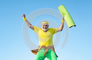 Funny Senior man Jumping. Old man jumping on blue sky background. Freedom retirement concept. Fit senior man resting