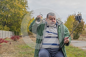 Funny senior man making faces while doing selfie