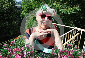 Funny senior woman against summer background